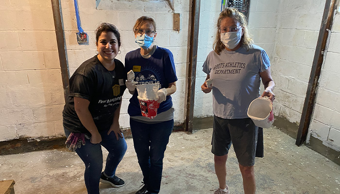 First Merchants Team Members working in the homes basement.
