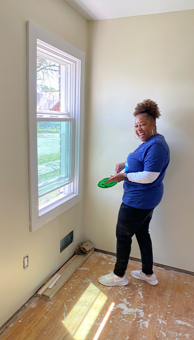 First Merchants Team Member painting a bedroom.