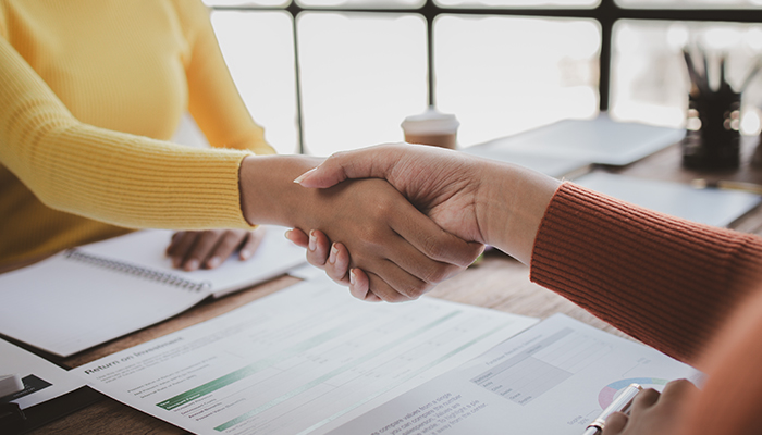 Shaking hands with a banking at their office