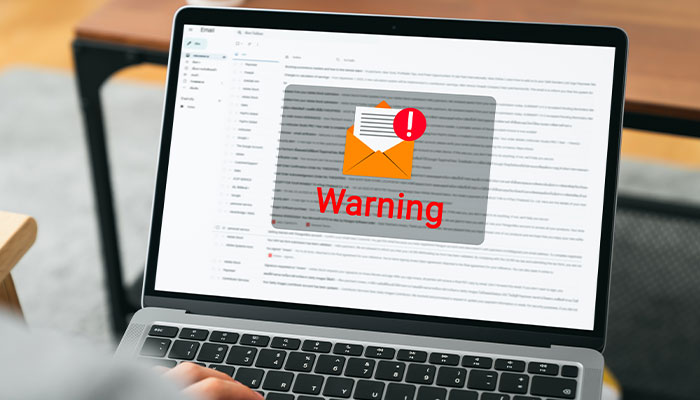 SC-Email-Fraud-Tatics700x400 Computer screen with a email warning icon displaying in the middle.