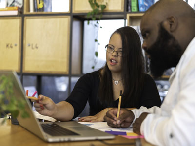 BusinessMainCardImage Teacher working with individual