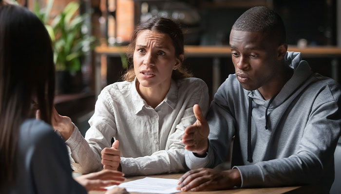 Multi-racial couple talking to a professional