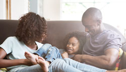 African-American-Family-on-couch-laughing-Web